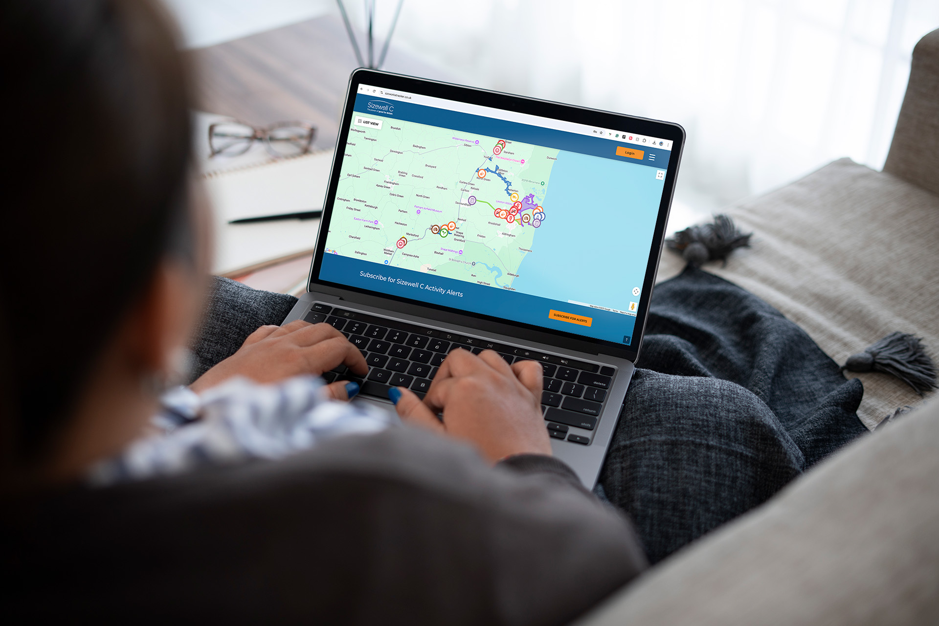 Woman using SZC Works Tracker on laptop