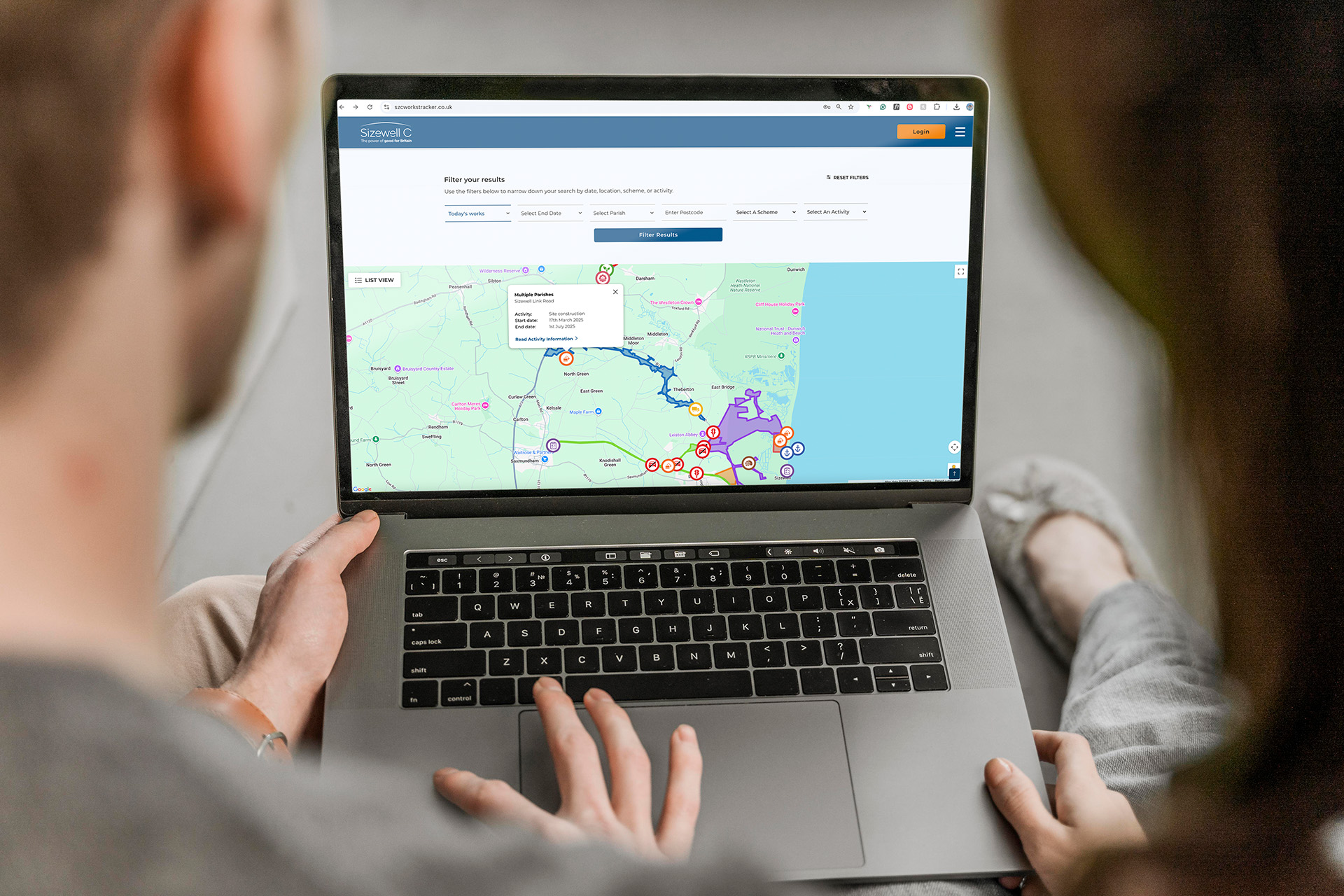 Couple using SZC Works Tracker on laptop